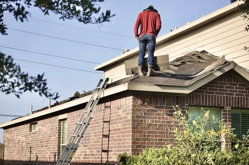 Professional roofer working on a residential roof in Whitehall